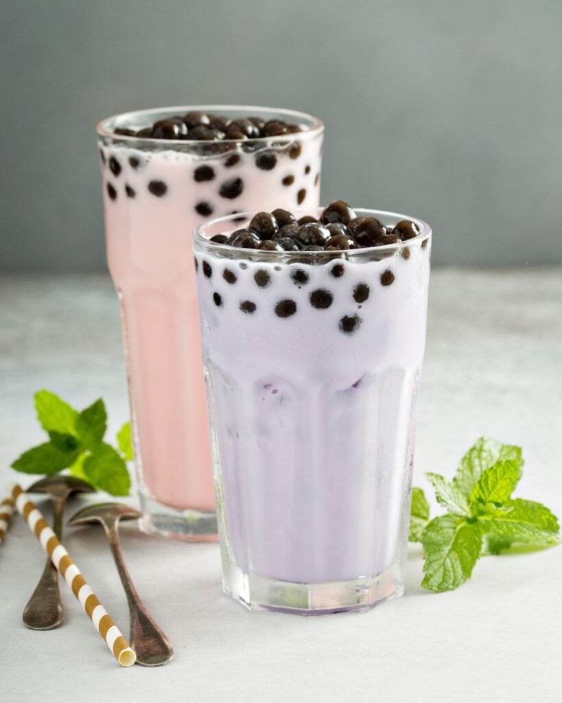 Taro and strawberry milk bubble tea in tall glasses